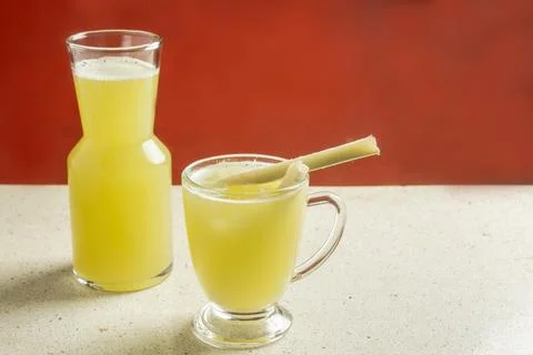 Sugarcane juice in two parallel glasses on a granite texture table Stock Photos