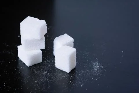Sugar.Cubes on black Stock Photos