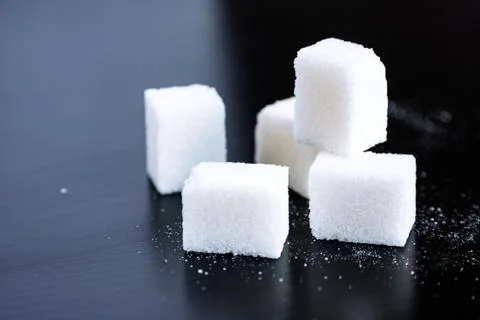 Sugar.Cubes on black Stock Photos