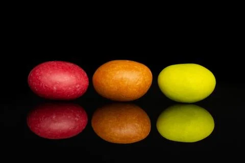 Sugared nut dragee isolated on black glass Stock Photos