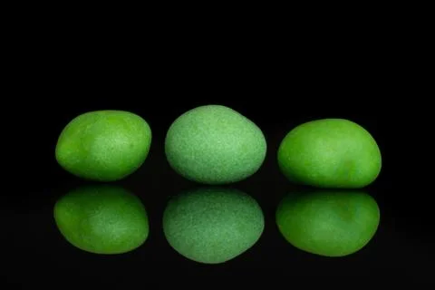 Sugared nut dragee isolated on black glass Stock Photos