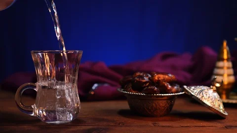 Suhoor or iftar time during Ramadan. A glass of water and dates Stock Footage 128278393