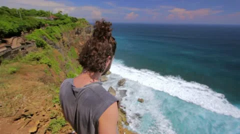 Suicidal young man at the edge of cliff Stock Footage 12175312