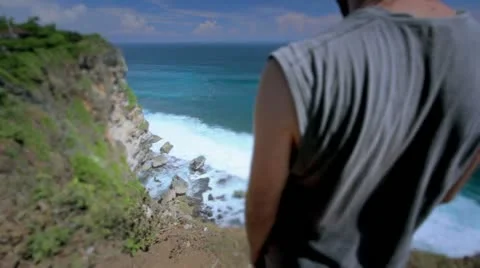 Suicidal young man at the edge of cliff, retouched Stock Footage 12175320
