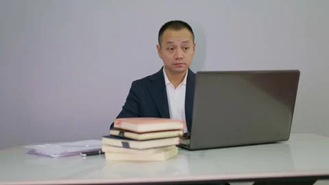 Suit man started massaging his eyes because his eyes feel tired Stock Footage 320093381