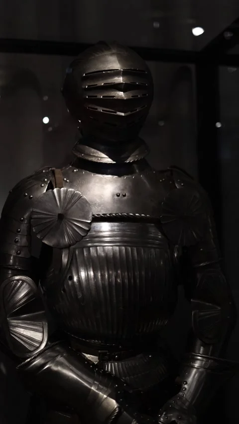 A suit of medieval knight armor displayed under dim lighting, showcasing intrica Stock Footage 289638034