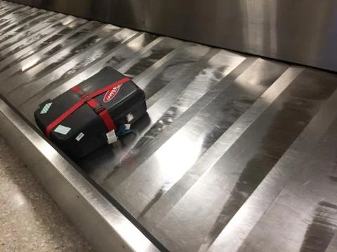 Suitcase alone on carousel Stock Photos