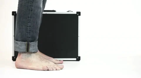 Suitcase and barefooted men Stock Footage 20011435
