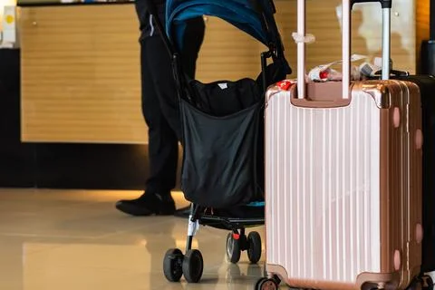 Suitcase and stroller Stock Photos