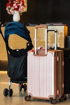 Suitcase and stroller Stock Photos