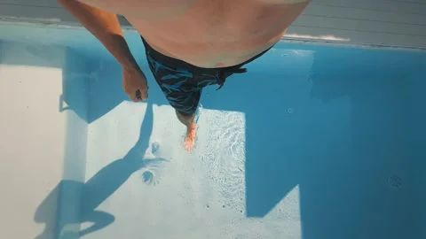 Suitcase carrying man steps onto poolside terrace, suitcase premium travel Stock Footage 312748801