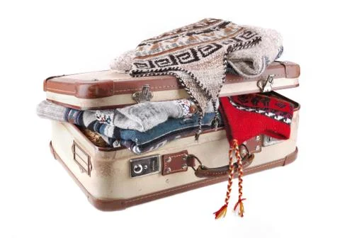 Suitcase full of woolen clothes Stock Photos