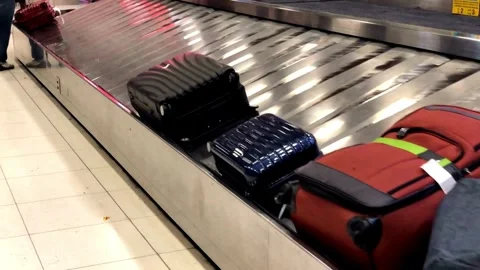 Suitcase moving along a baggage carousel in a modern airport Closeup low angl Stock Footage 256744029