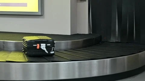 Suitcase moving along a baggage carousel in a modern airport Closeup low angl Stock-Footage 256745762