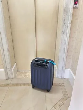 Suitcase Next to Elevator Stock Photos