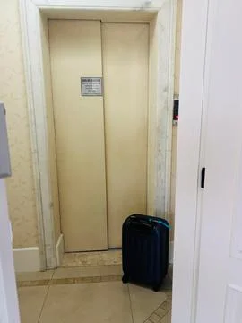 Suitcase next to the elevator Stock Photos
