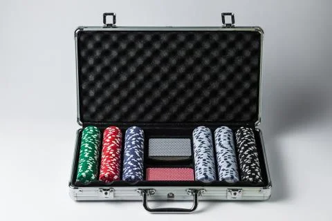 Suitcase with poker set on a light background Stock Photos