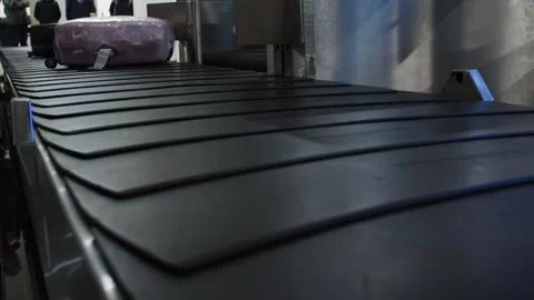 Suitcases getting dropped on the baggage carousel at an airport, 4k Stock-Footage 346705016