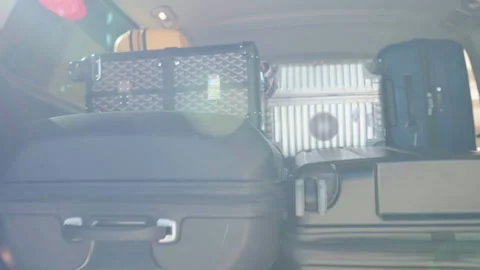 Suitcases loaded in car trunk, rear view of van trunk with trip luggage Stock Footage 303749321