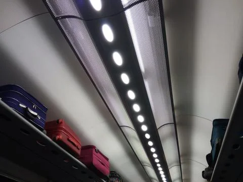 Suitcases on a rack on a train Stock Photos