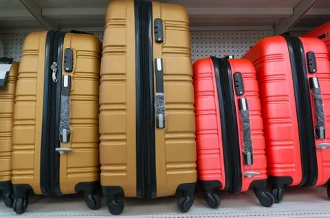 Suitcases in a row on shelf Stock Photos