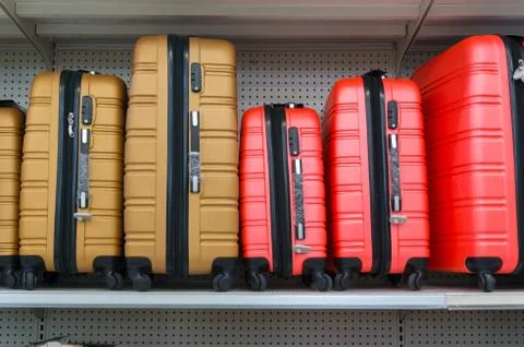 Suitcases in a row on shelf Stock Photos