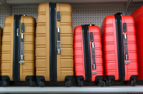 Suitcases in a row on shelf Stock Photos