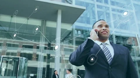 Suited man calling smartphone, activating network linking nodes to him at office Stock Footage 335465729