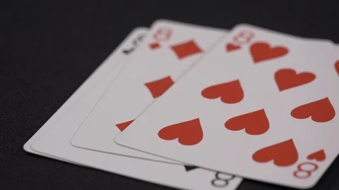 Suits of playing cards, Eight moving on a luxury black background 4k. Stock Footage 95564649