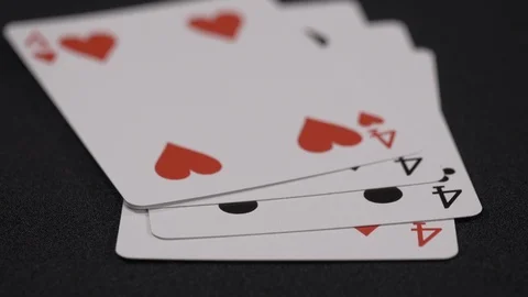 Suits of playing cards, Four moving on a luxury black background 4k. Stock Footage 95564804