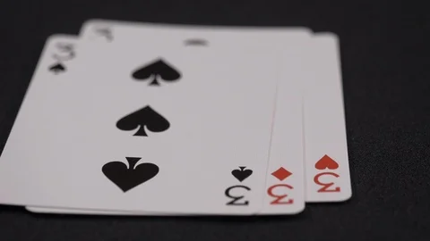 Suits of playing cards, Three moving on a luxury black background 4k Stock Footage 95566553