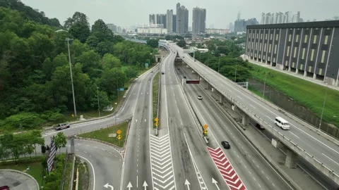 SUKE Elevated Highway junction with city skyline and green hills 動画素材 337332215