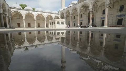 Suleymaniye Mosque interior courtyard reflected in puddle Stock Footage 90703947