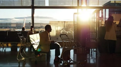 Sulhouettes of Passengers Waiting in a Queue For Boarding at the Gate in Stock Footage 68115713