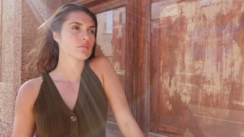 Sum Beaming Through a Female Model as She Leans Against Wooden Door Stock-Footage 112023686