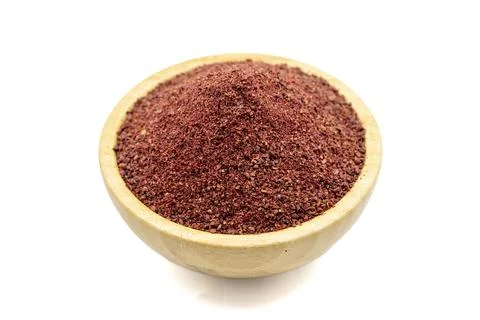 Sumac isolated on white background. Dried ground red Sumac powder spices in w Stock Photos