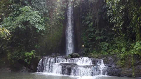 Sumampan Waterfall Flowing Into Tranquil Forest Pool Stock Footage 342296627