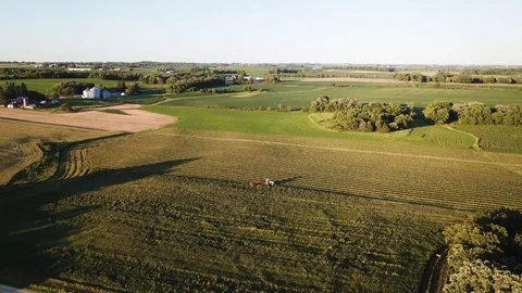 Summer 4k drone aeriel view Iowa farmer cutting hay mid summer at sunset Stock Footage 119739448