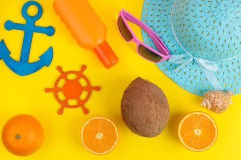Summer accessories. beach accessories. sunscreen, hat, coconut, orange and gl Stock Photos