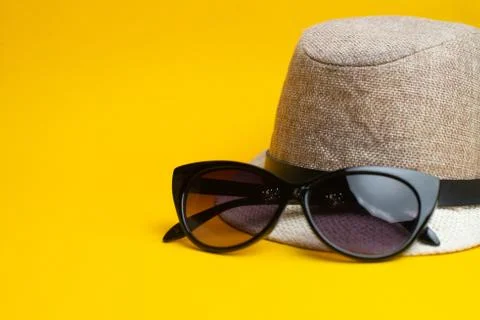 Summer accessories, shells, hat and sun glasses on yellow background. Summer  Stock Photos