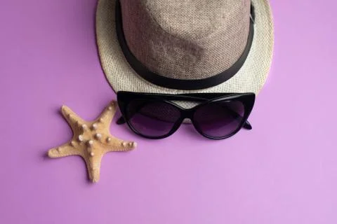 Summer accessories, shells, hat and sun glasses on light pink background. Sum Stock Photos