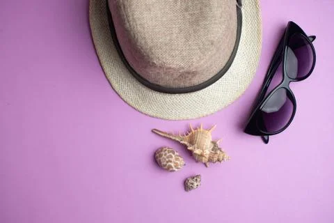 Summer accessories, shells, hat and sun glasses on pink background. Summer va 스톡 사진