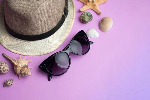 Summer accessories, shells, hat and sun glasses on pink background. Summer va Stock Photos