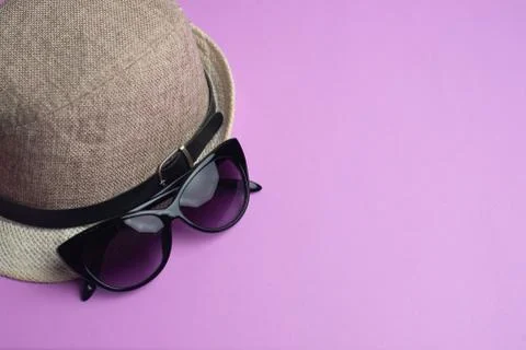 Summer accessories, shells, hat and sun glasses on pink background. Summer va Stock Photos