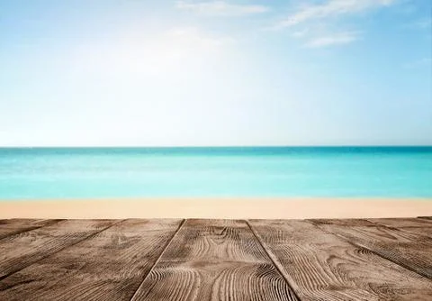 Summer background, close up of old empty wooden pier over the turquoise ocean Stock Photos