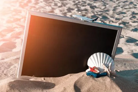 Summer background table. Globe, seashell, airplane and starfish near black de Stock Photos