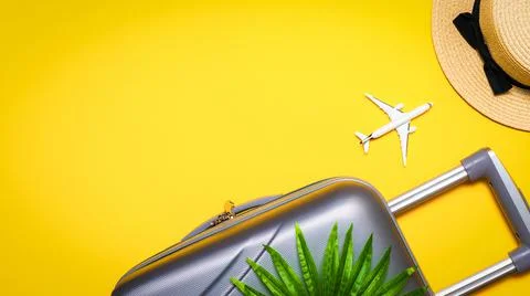 Summer background table. Suitcase, sunglasses with palm leaves and straw hat, Stock Photos