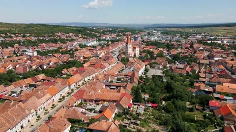 Summer backward flight over a town in Cisnadie, Sibiu, Transylvania, Romania Stock Footage