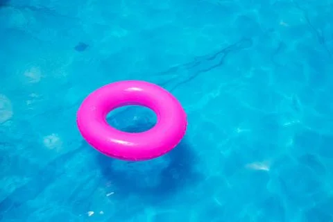Summer backyard pool with float in blue water Stock Photos