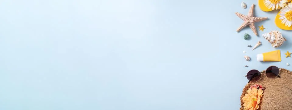 Summer beach background design concept with shells, hat, slipper on yellow ba Stock Photos